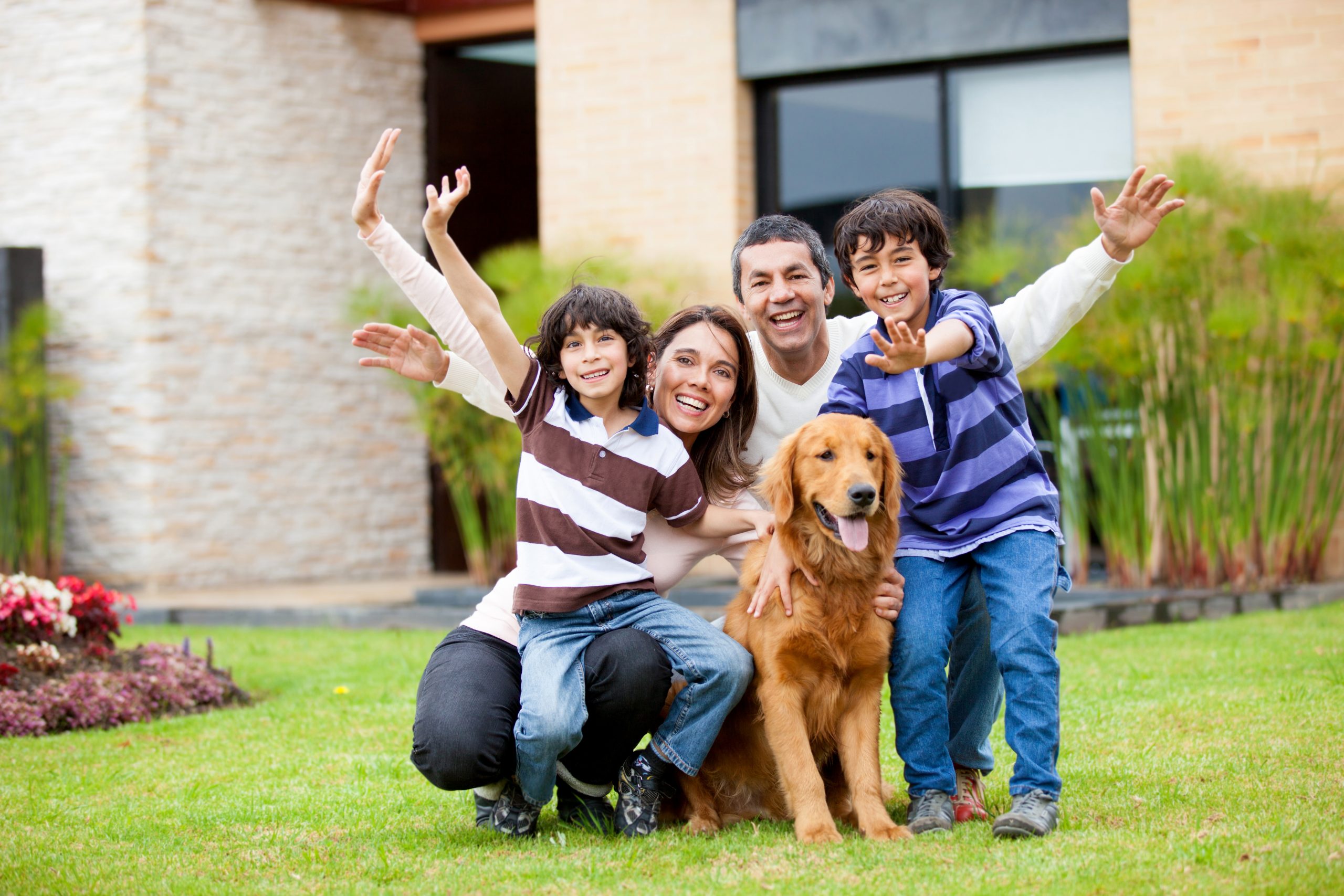 Happy,Family,With,A,Dog,Outside,Their,House
